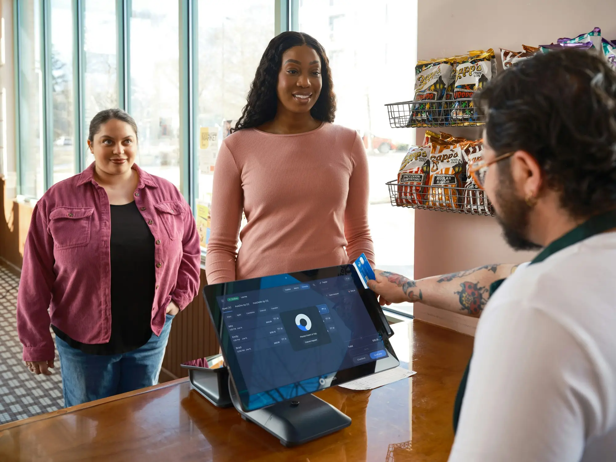 Customers at the counter of a small shop